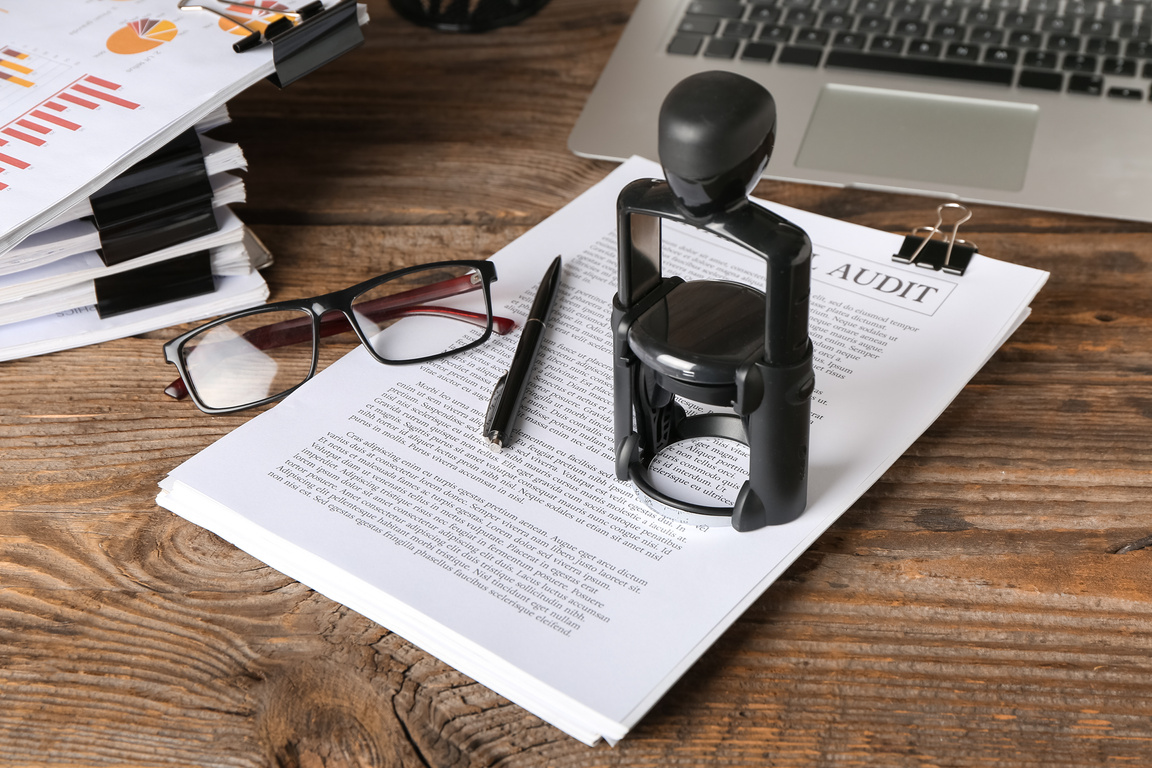 Documents and Stamp of Notary Public on Wooden Table